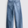 7-15 jaar | Jeans met wijde pijpen en geborduurde bloemenstrik
