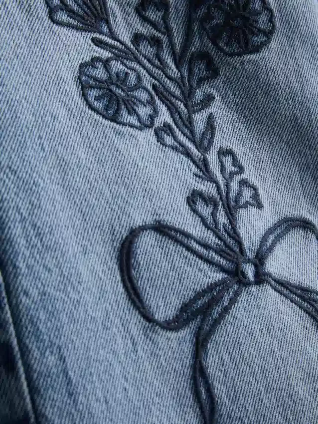 7-15 jaar | Jeans met wijde pijpen en geborduurde bloemenstrik