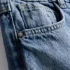 7-15 jaar | Jeans met wijde pijpen en geborduurde bloemenstrik