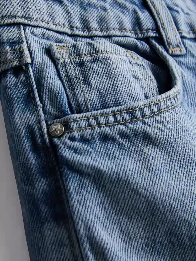 7-15 jaar | Jeans met wijde pijpen en geborduurde bloemenstrik