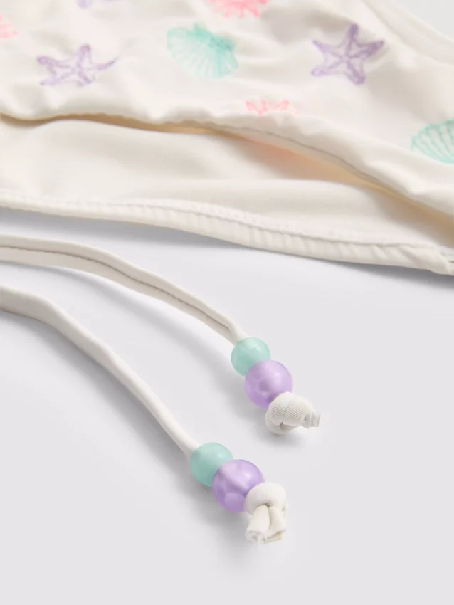 Bikinibroekje met borduursel en strik aan de zijkant