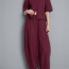 Broek met plooien en wijd uitlopende pijpen met papierachtige textuur