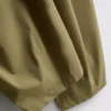 Broek met plooien en wijd uitlopende pijpen met papierachtige textuur