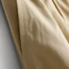 Broek met plooien en wijd uitlopende pijpen met papierachtige textuur