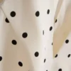 Peplumtop met halternek en stippen