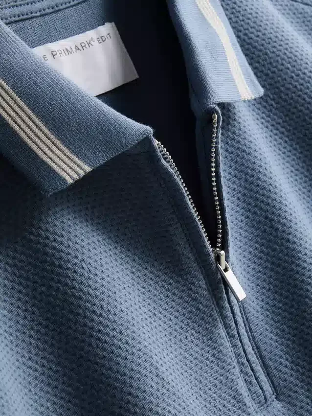 Polo met ritssluiting en structuur