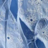 Top met broderie en strik aan de zijkant